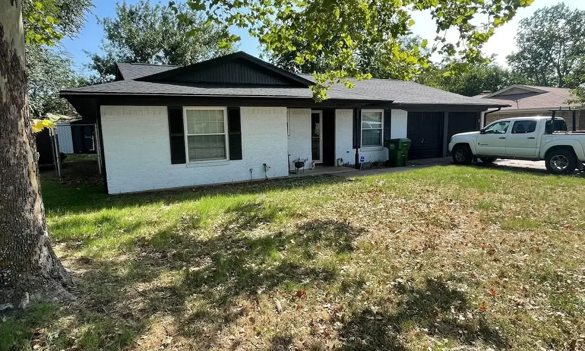 Professional roofing crew working on a residential roof in Caln